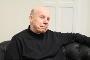 Dr. Donal Malone of the Saint Peter's University Sociology Department seated on a couch.  